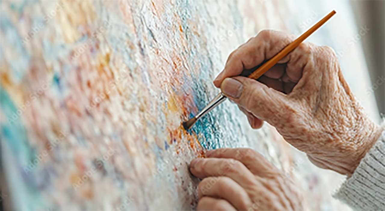 Patient painting on a canvas, a form of visual art therapy